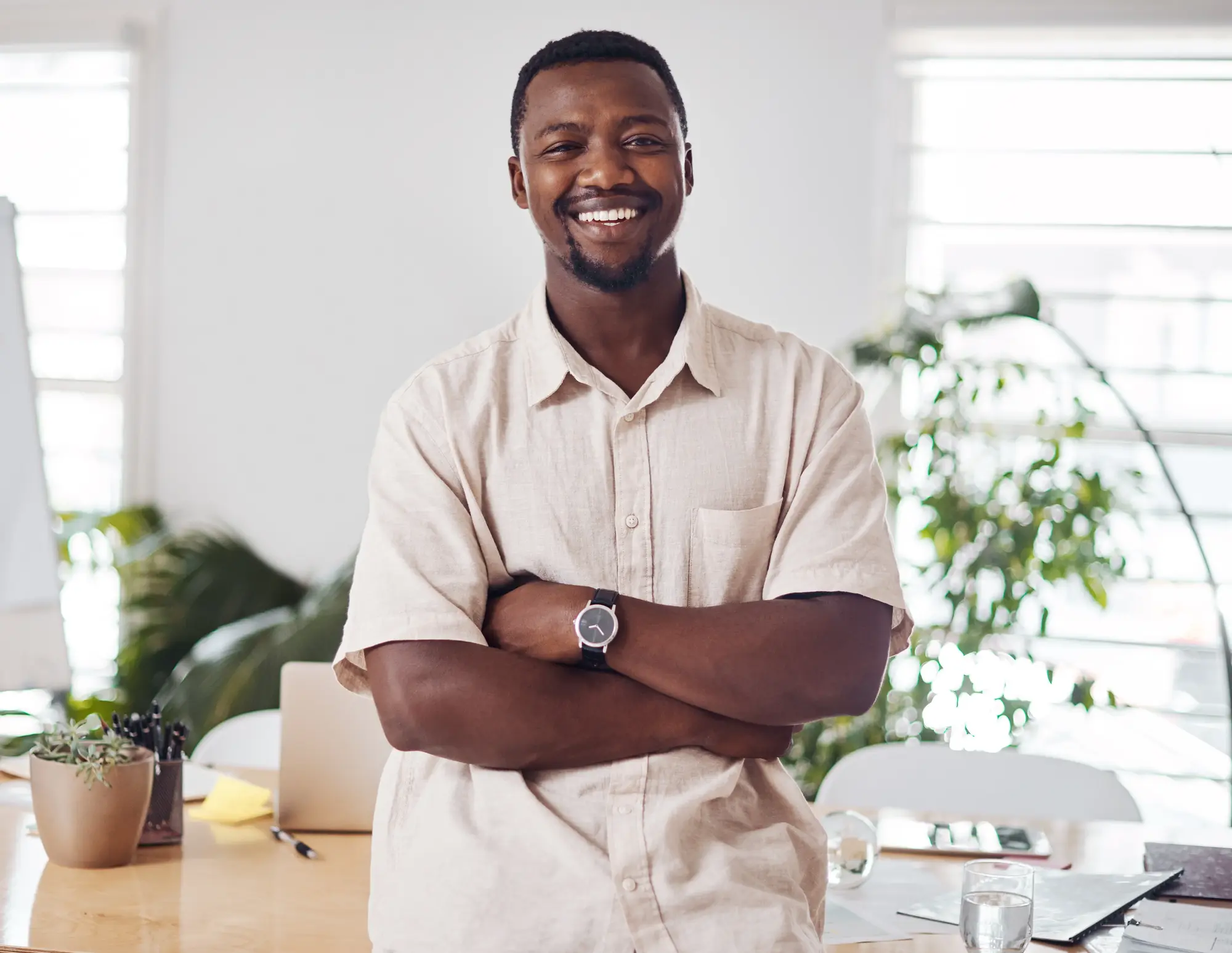 A confident man smiling in a bright, modern interior